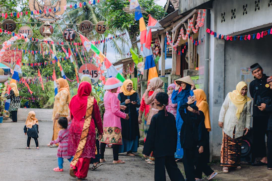 A lively street scene on Boundary Road with people in colorful traditional attire celebrating National Dress Day.