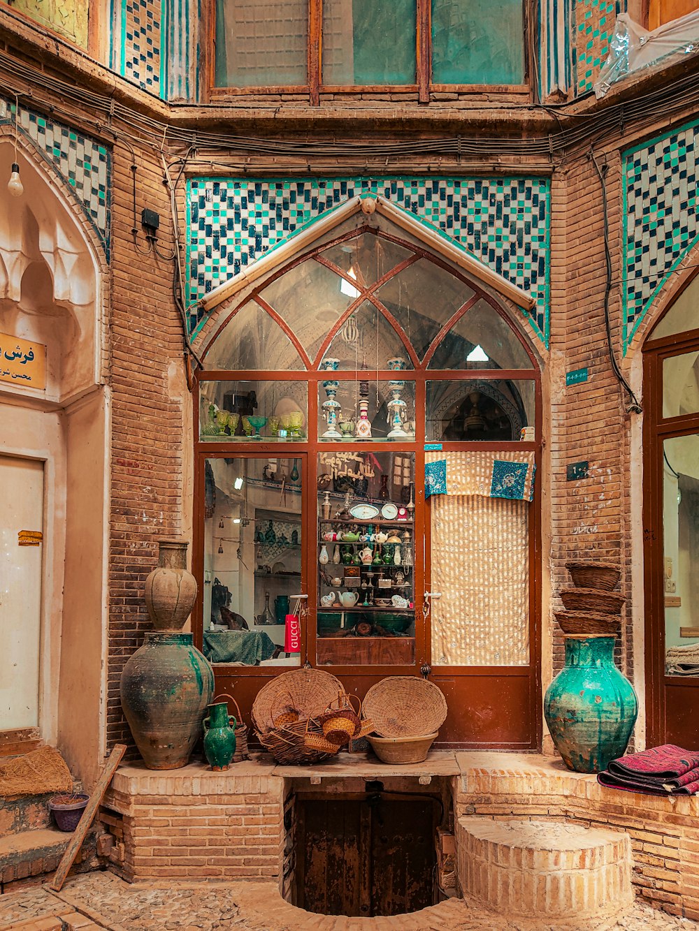 a window with vases and vases in front of it