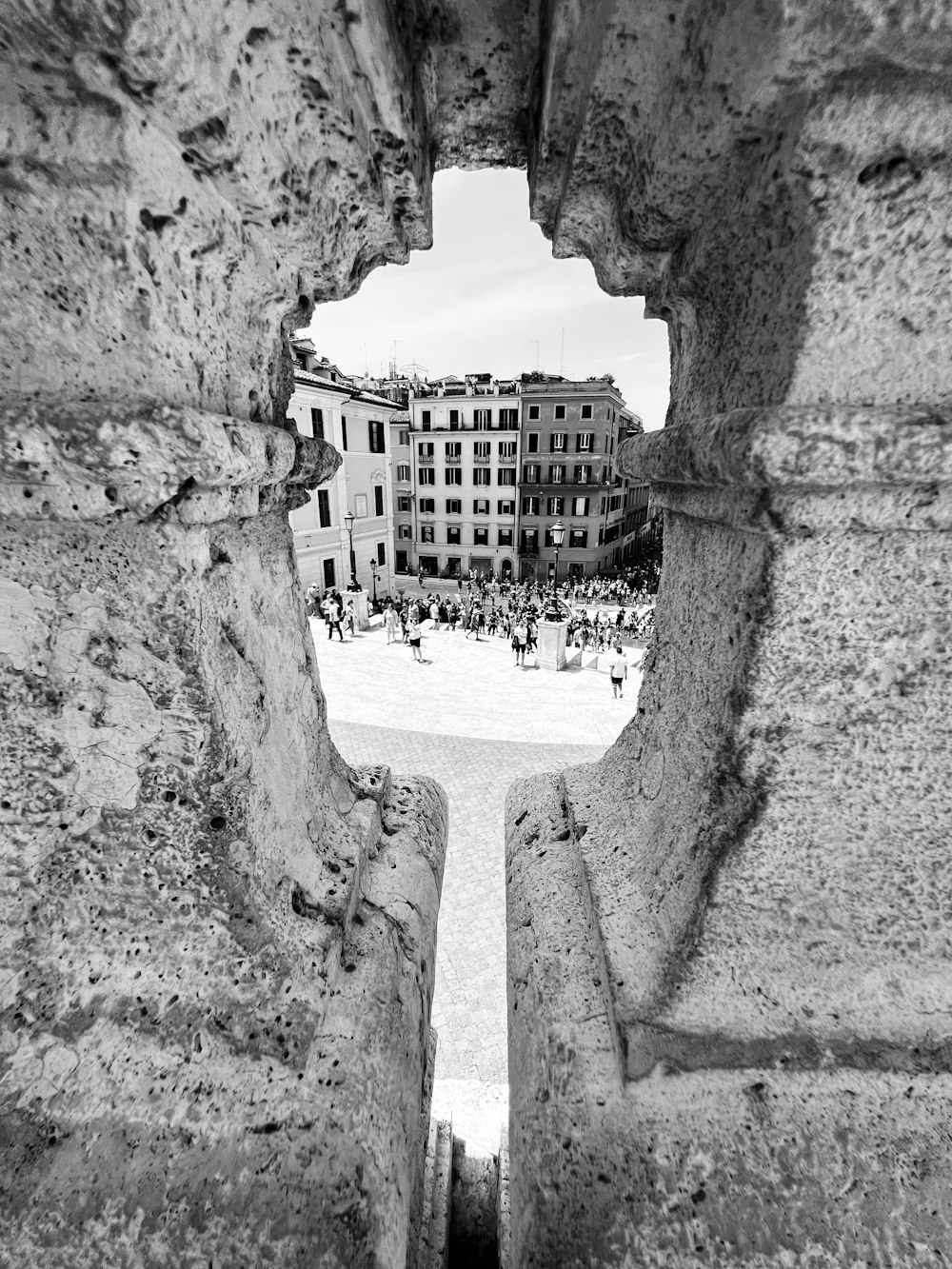 a view of a city through a stone archway