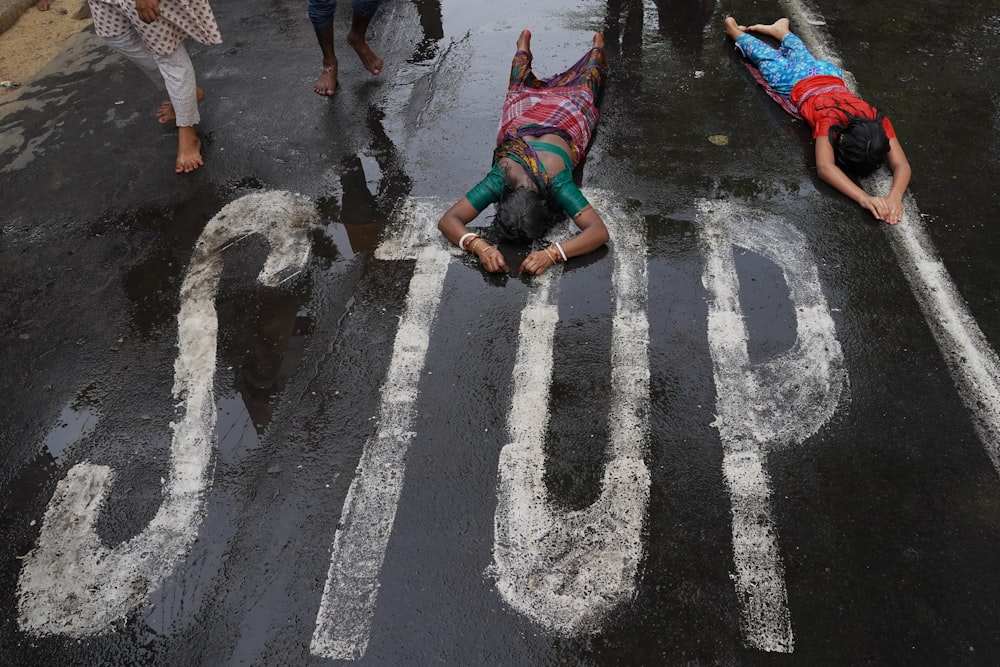 a group of people writing in the street