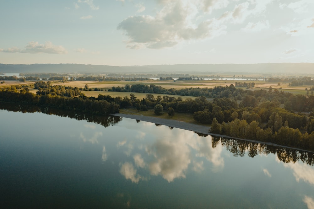 a body of water with trees and buildings around it