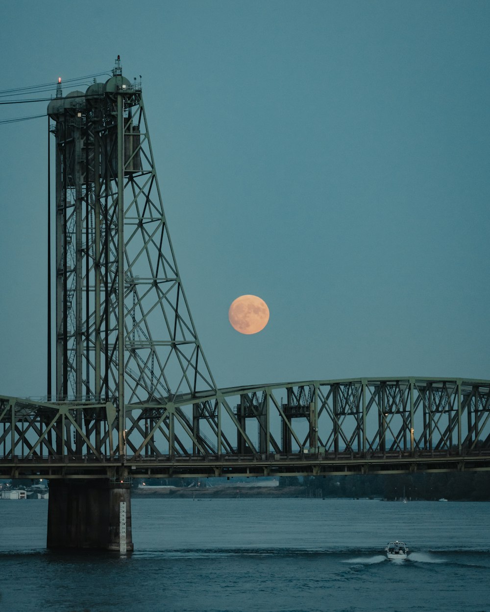 a bridge with a moon in the sky