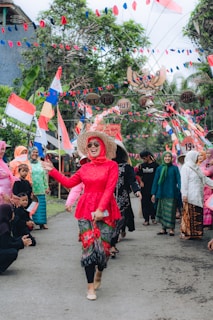 Festive scene of locals celebrating with colorful decorations and traditional attire.