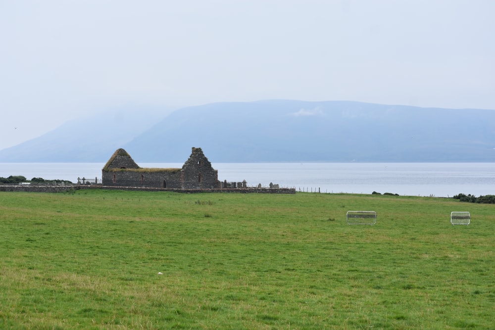 a grassy field with a building in the distance