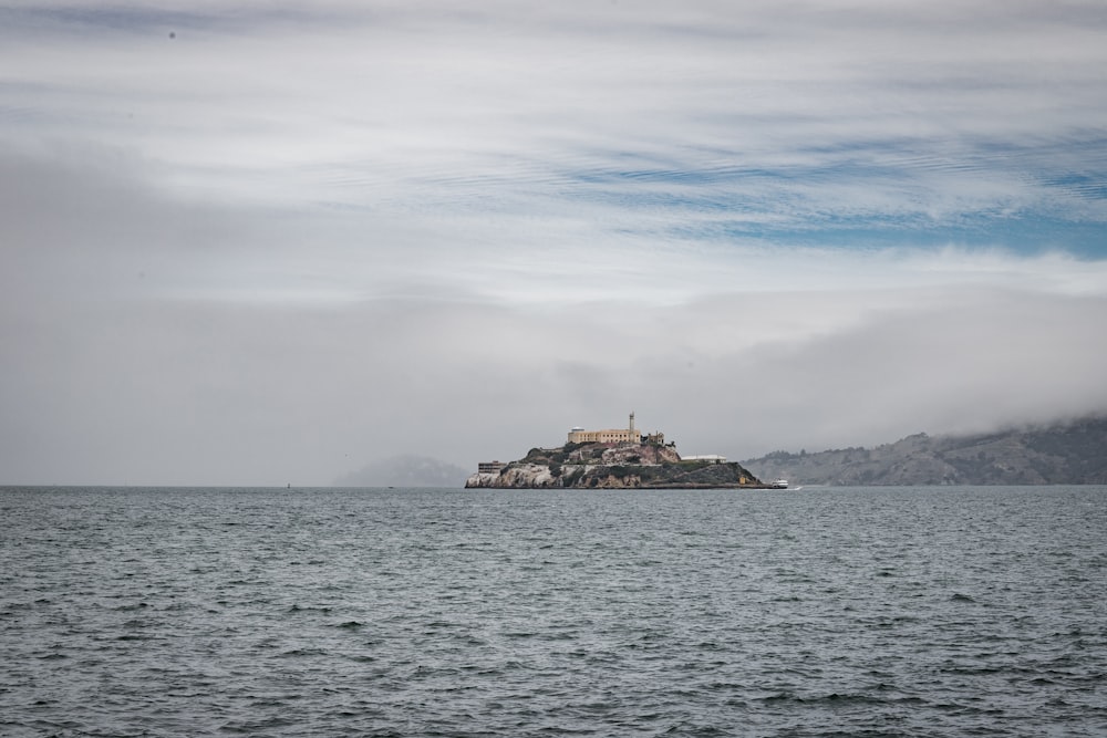 a small island with a building on it surrounded by water