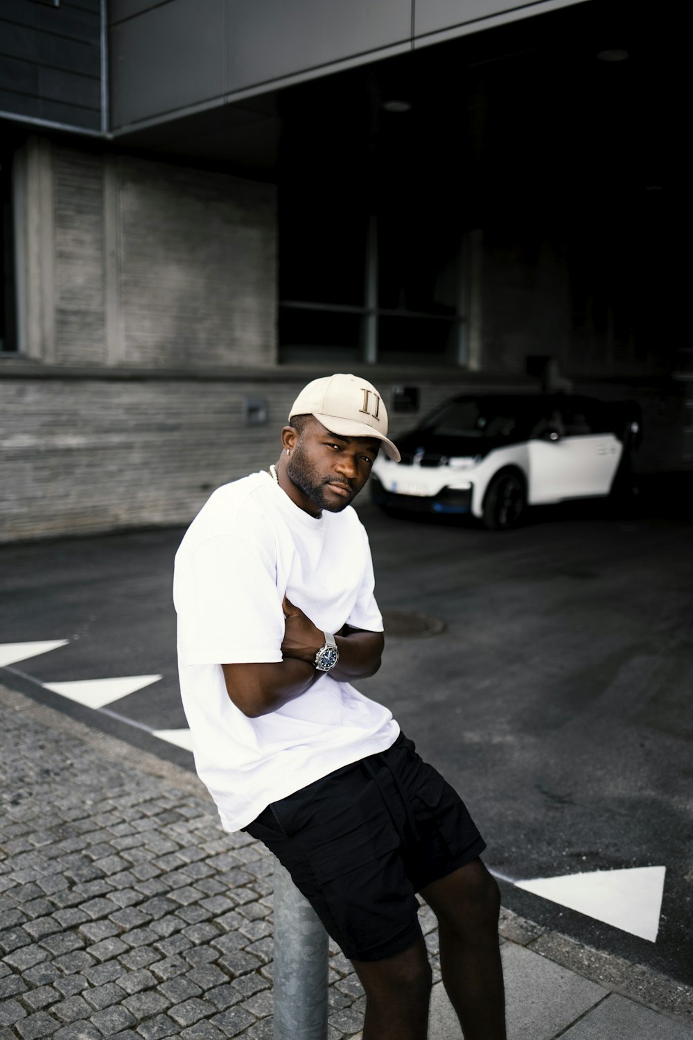 a man sitting on a sidewalk