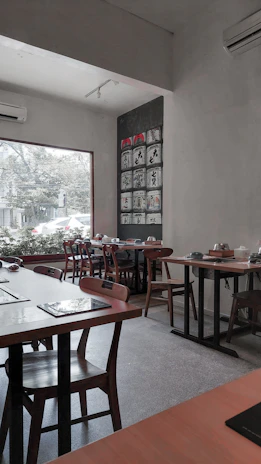 A cozy Scandinavian-style restaurant interior with artisanal dishes beautifully arranged on wooden tables.