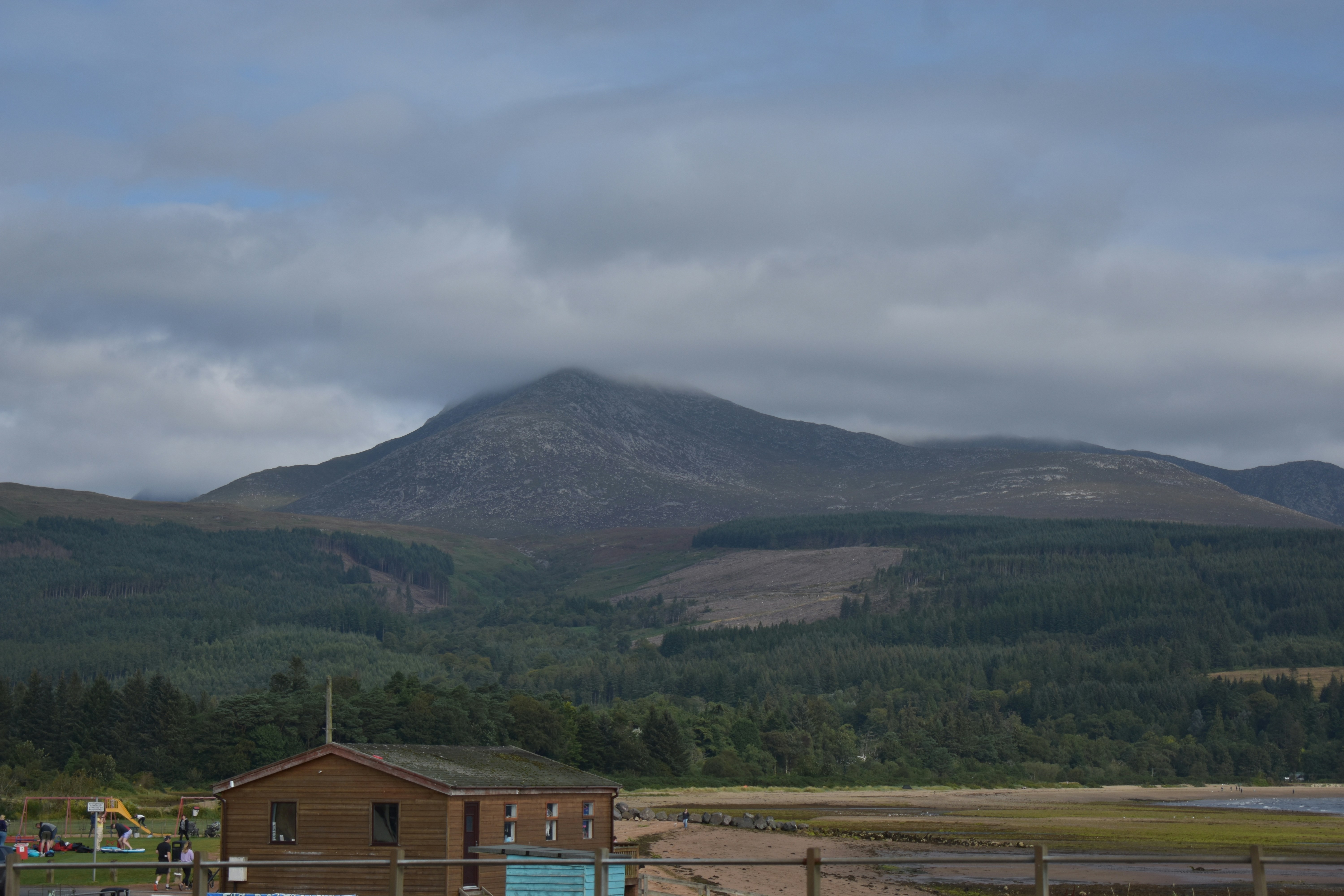 a building in front of a mountain
