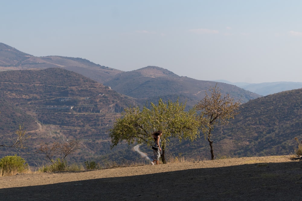 a person standing next to a tree