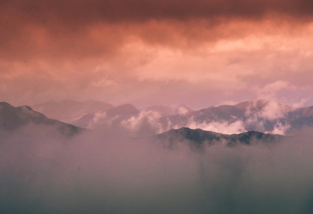 a foggy valley with mountains