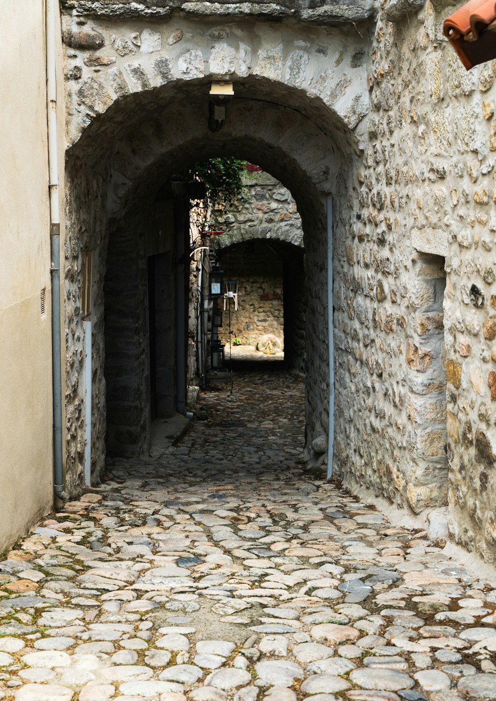 a stone walkway with a stone archway