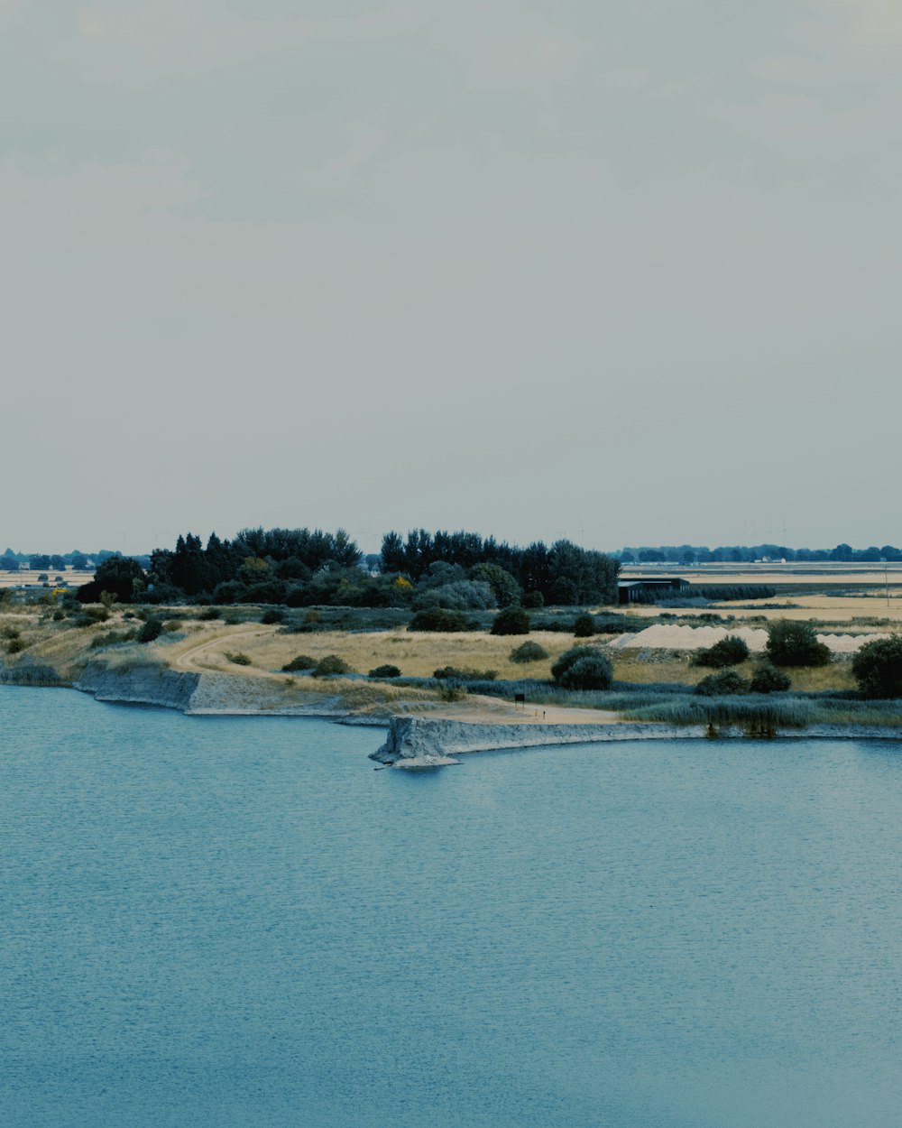 a body of water with land in the back