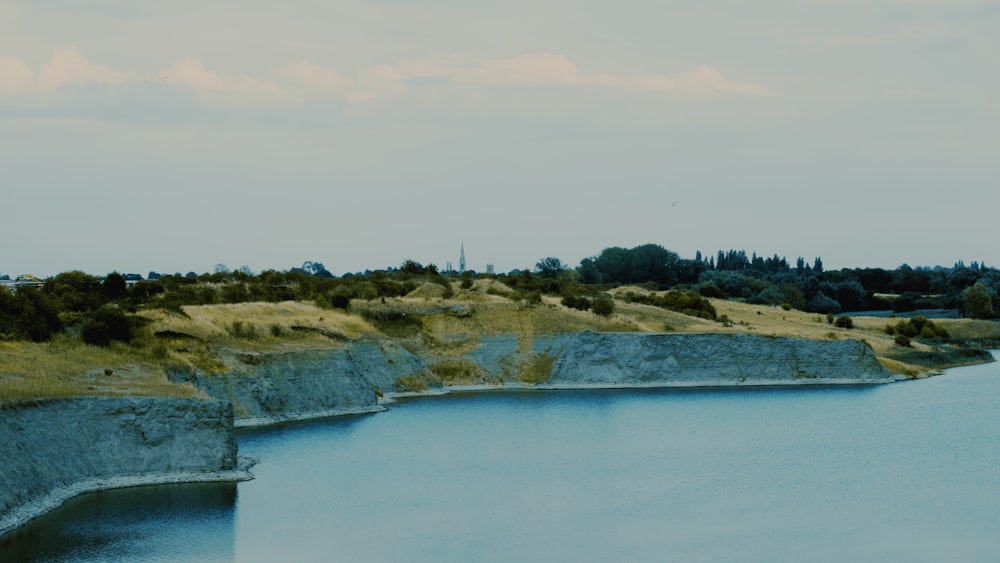 a body of water with land in the back