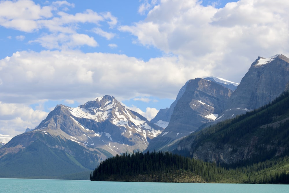 a body of water with mountains in the back