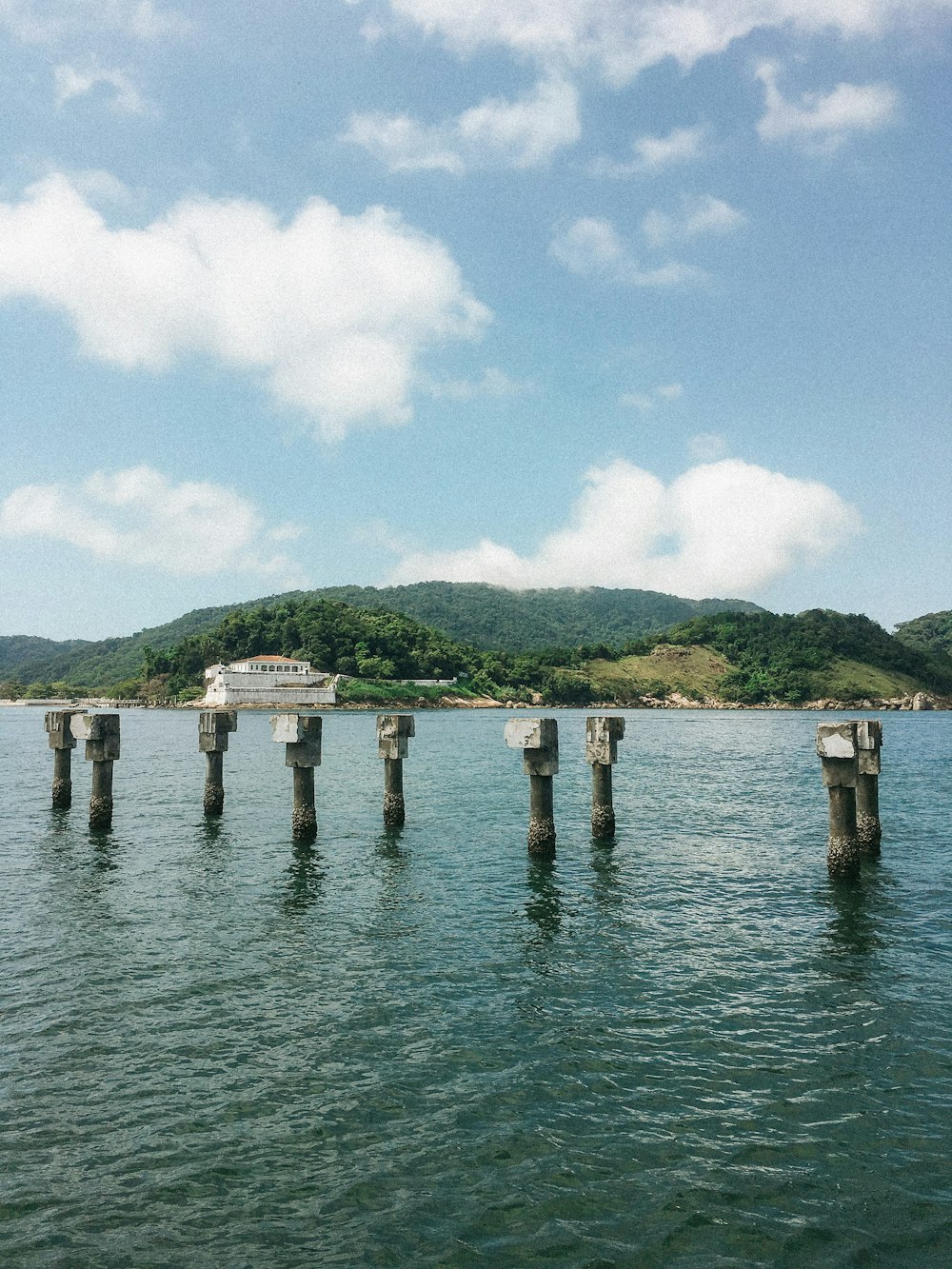 a body of water with a building on the shore