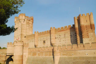 a stone castle with a blue sky
