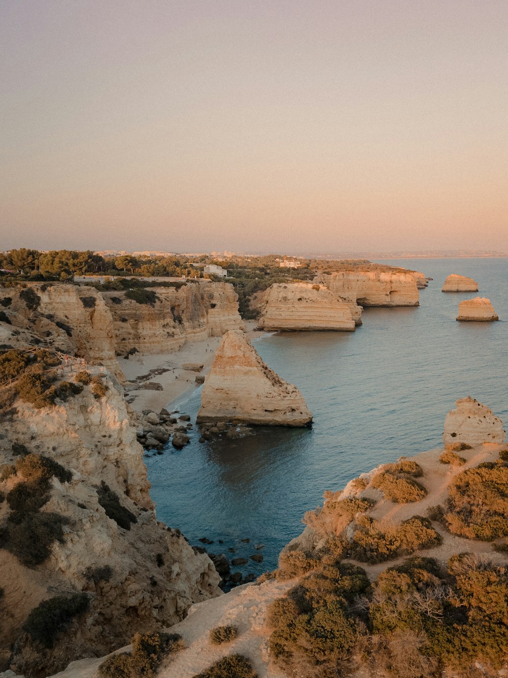 a rocky shoreline with a body of water in the background