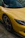 a yellow car with a black rim