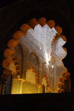 Soft morning light filtering through an elegant Islamic architectural archway.