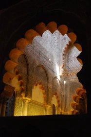 Soft morning light filtering through an elegant Islamic architectural archway.