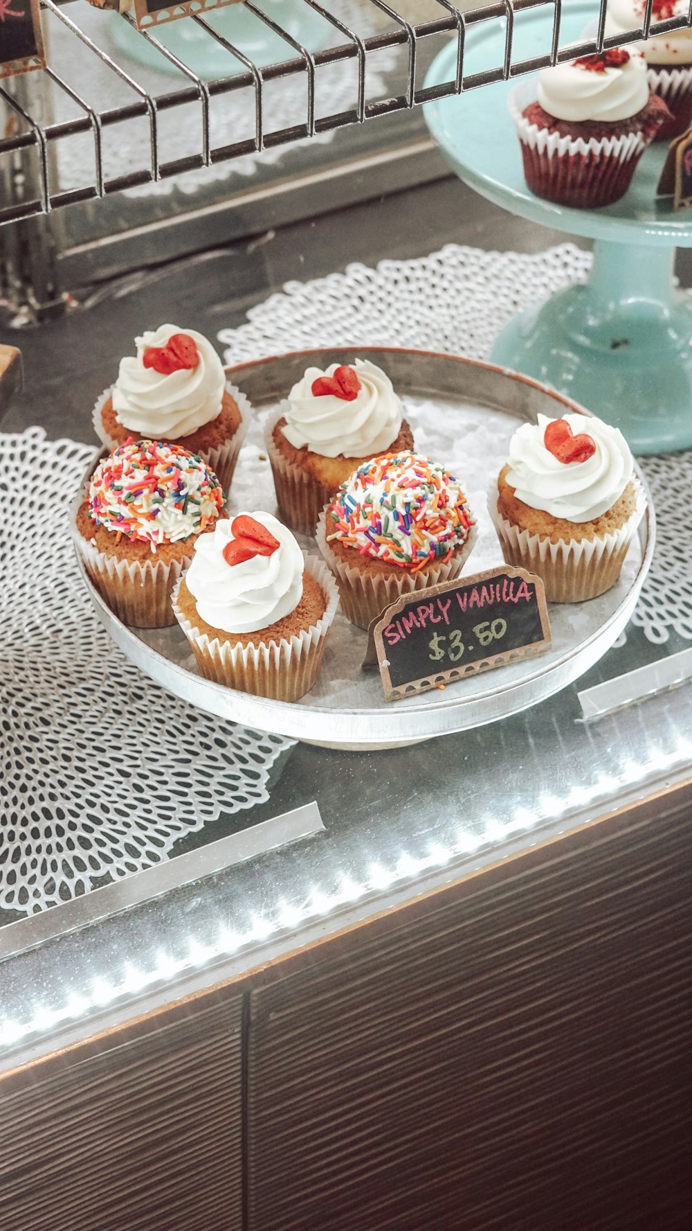 cupcakes with frosting and decorations on a glass table