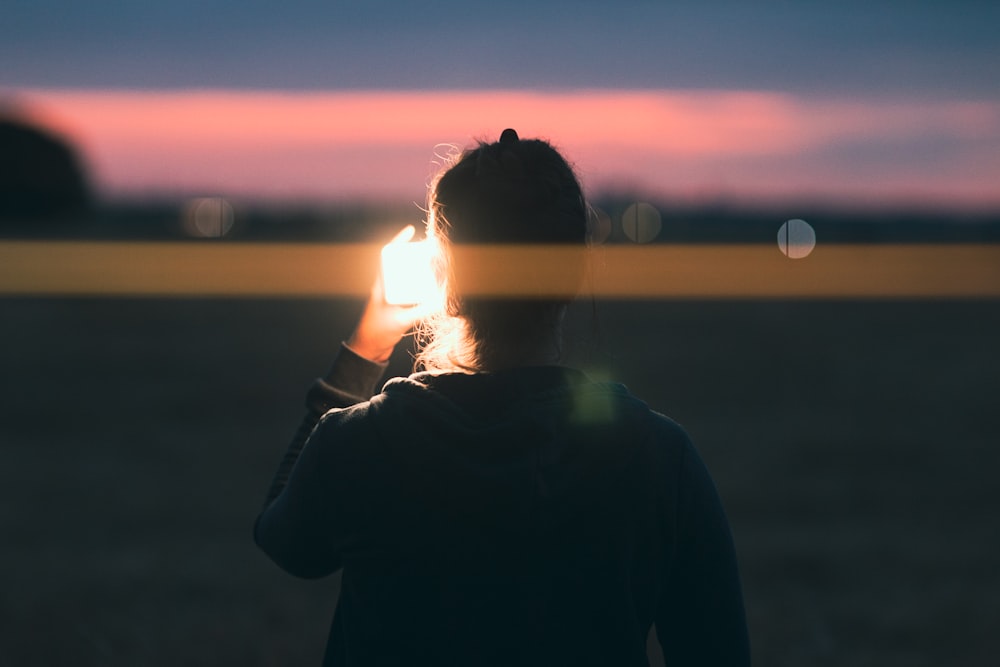 a person holding a light up to the face