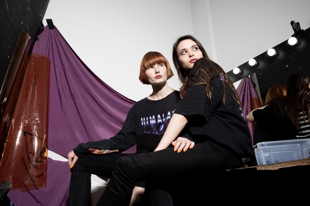 a couple of women sitting on a bench