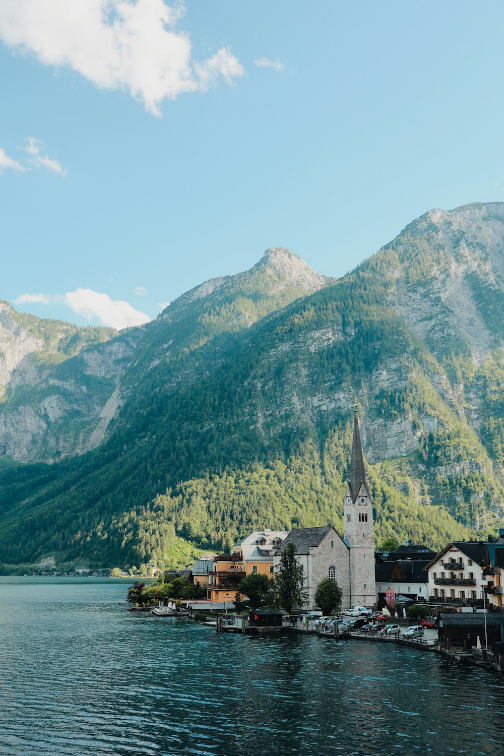 a town by a lake with mountains in the background