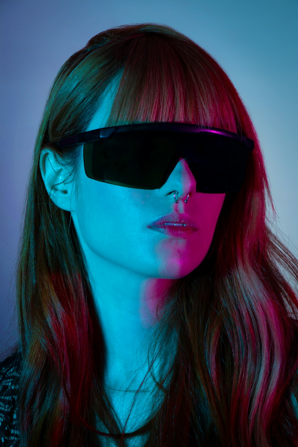 a woman with red hair and sunglasses