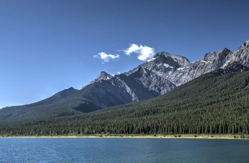 a body of water with mountains in the back