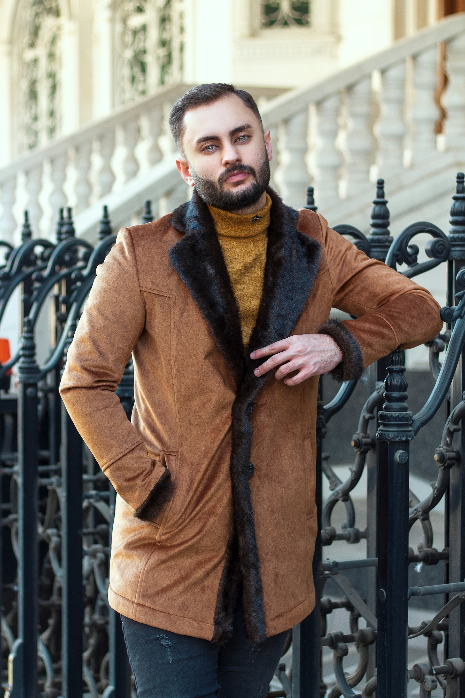 a person with a beard and a coat standing on a staircase