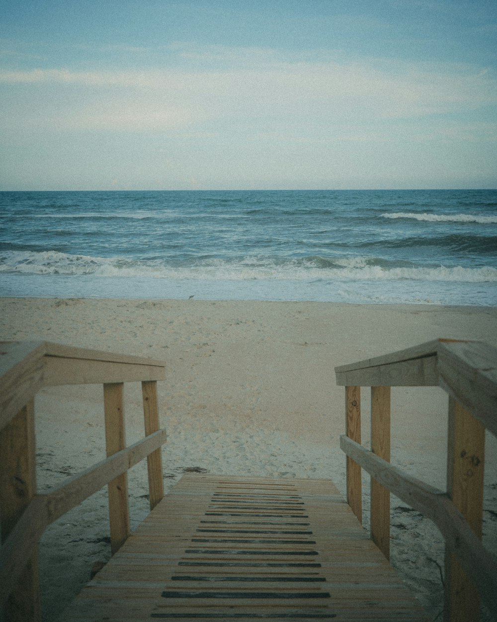 a wooden walkway on a beach