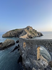 a stone structure on a cliff over the ocean
