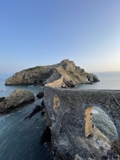 a stone structure on a cliff over the ocean