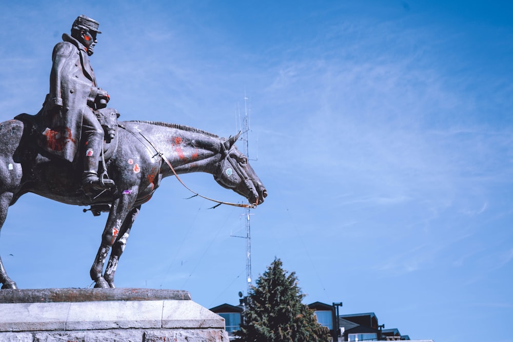 a statue of a person riding a horse