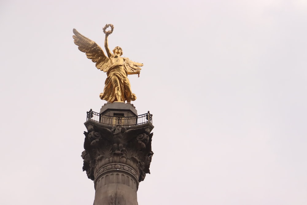 a golden statue on a pillar