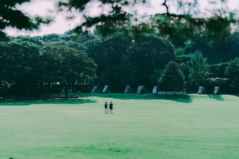 a couple people walking on a golf course