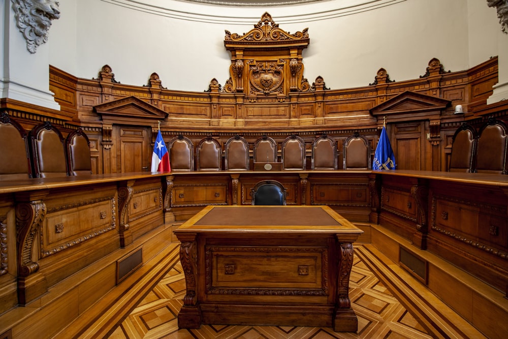 a courtroom with a large wooden bench