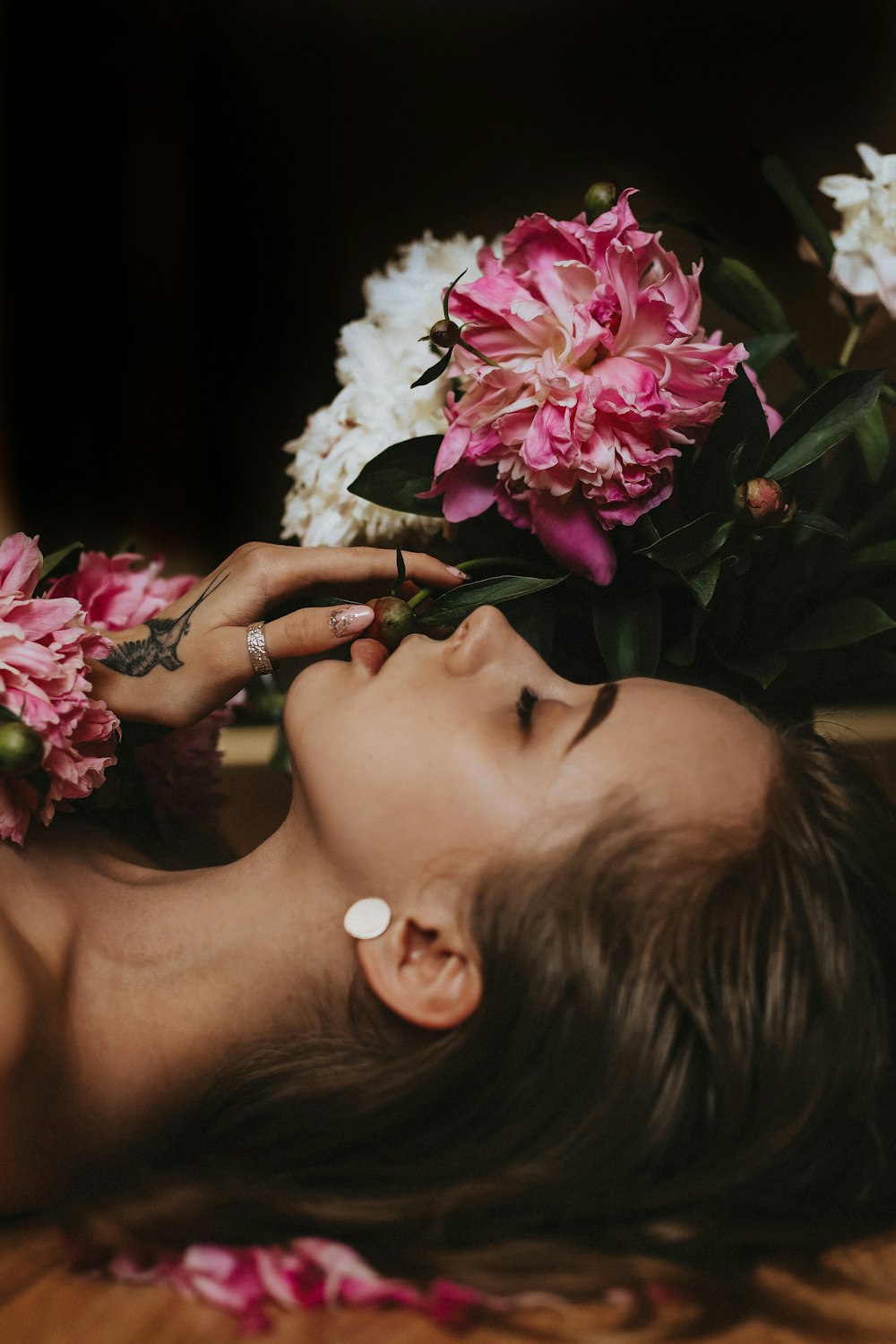 a woman lying down with flowers on her head