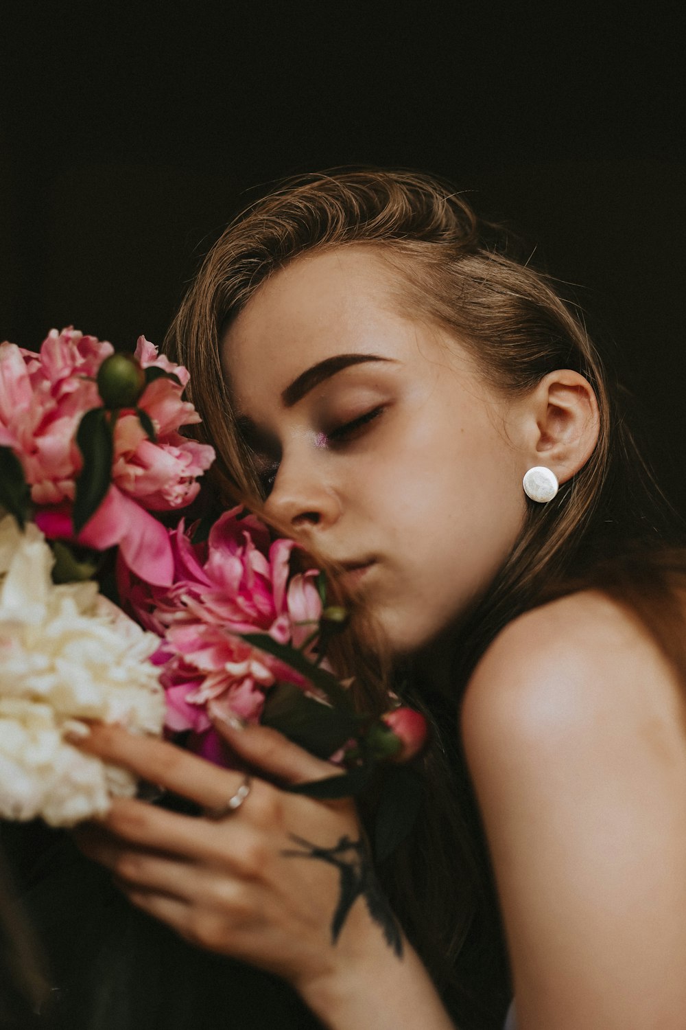 a woman smelling flowers