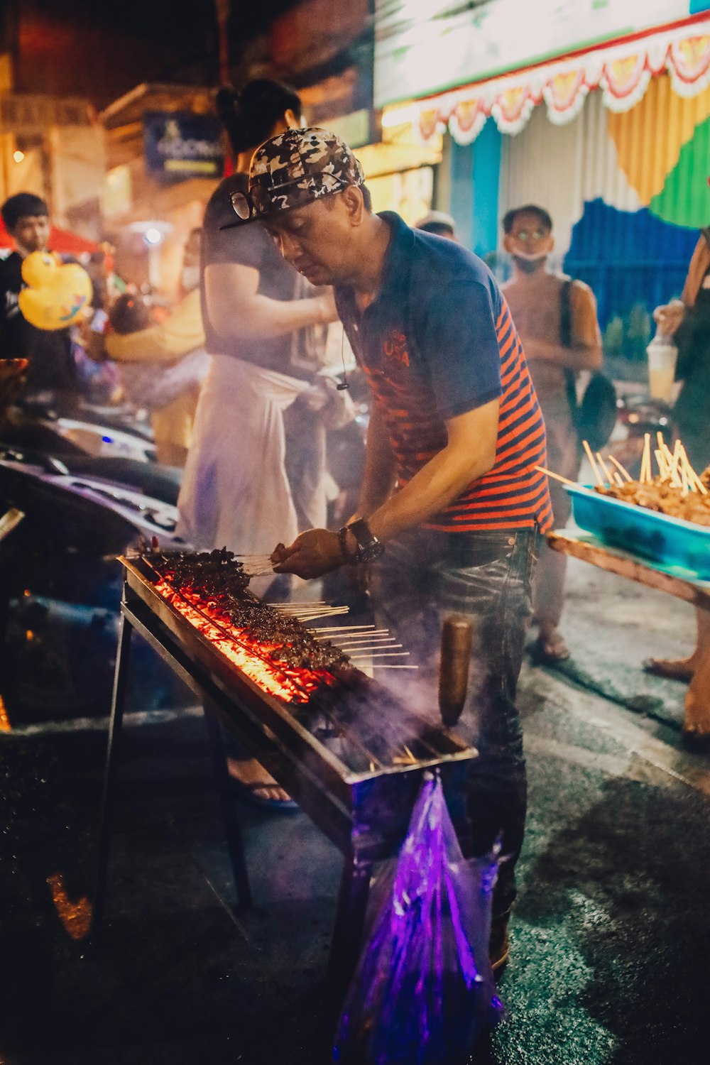 a man cooking food on a grill