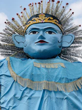 A regal portrait of King Kosoko in traditional Yoruba royal attire, set against a deep royal blue background with antique gold accents.
