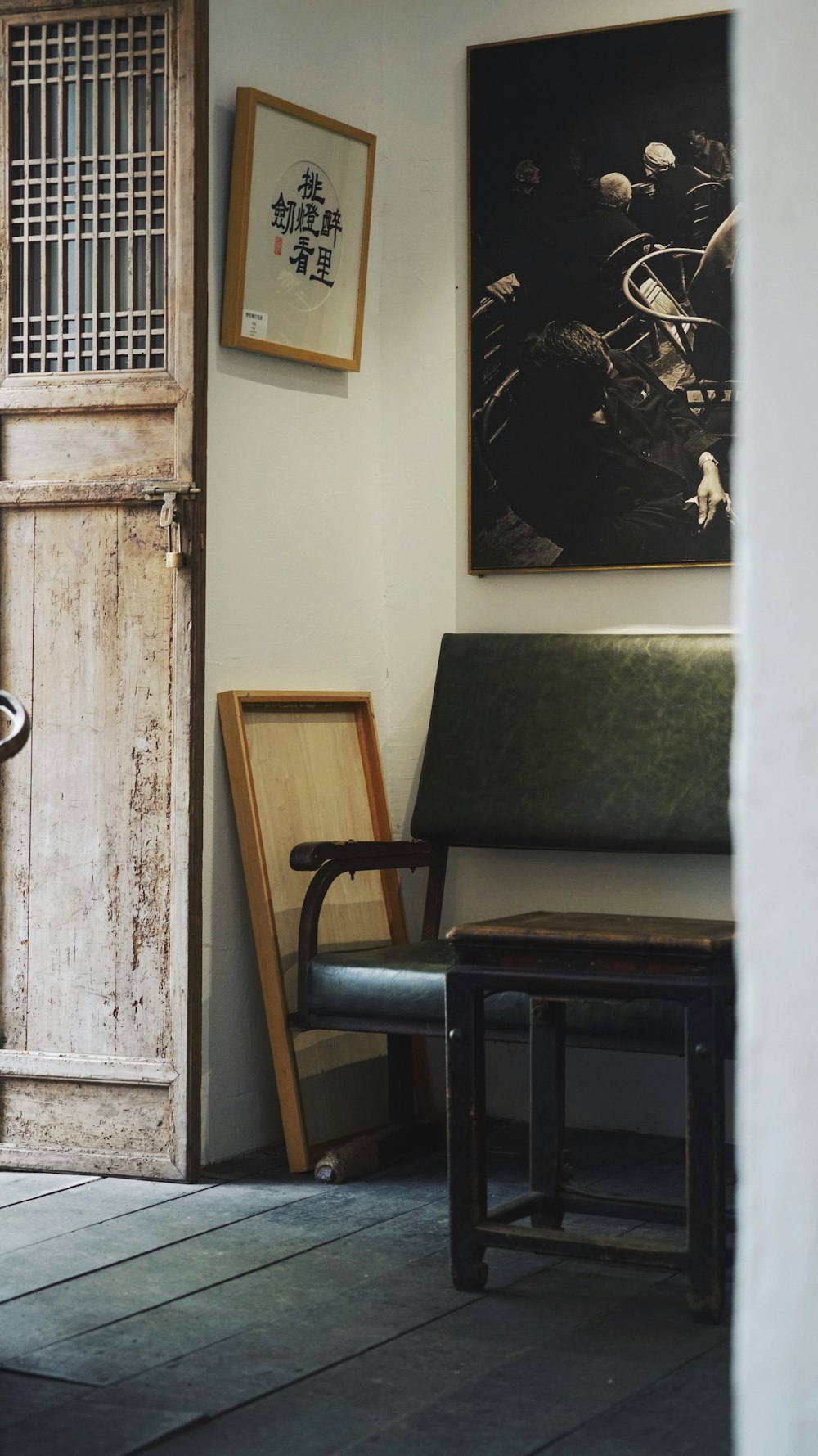 a chair and a table in a room with a poster on the wall