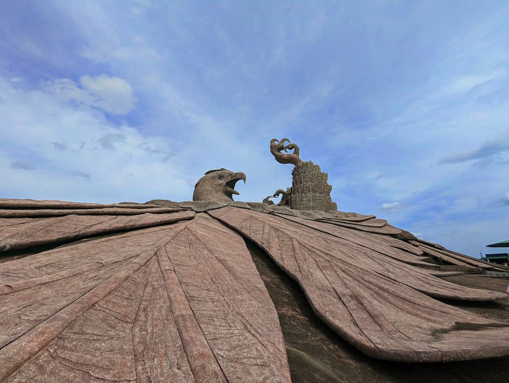 a couple of statues on top of a roof