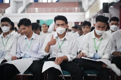 a group of people wearing white masks