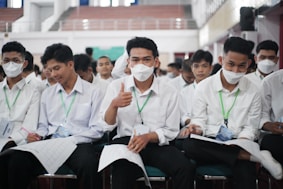 a group of people wearing white masks