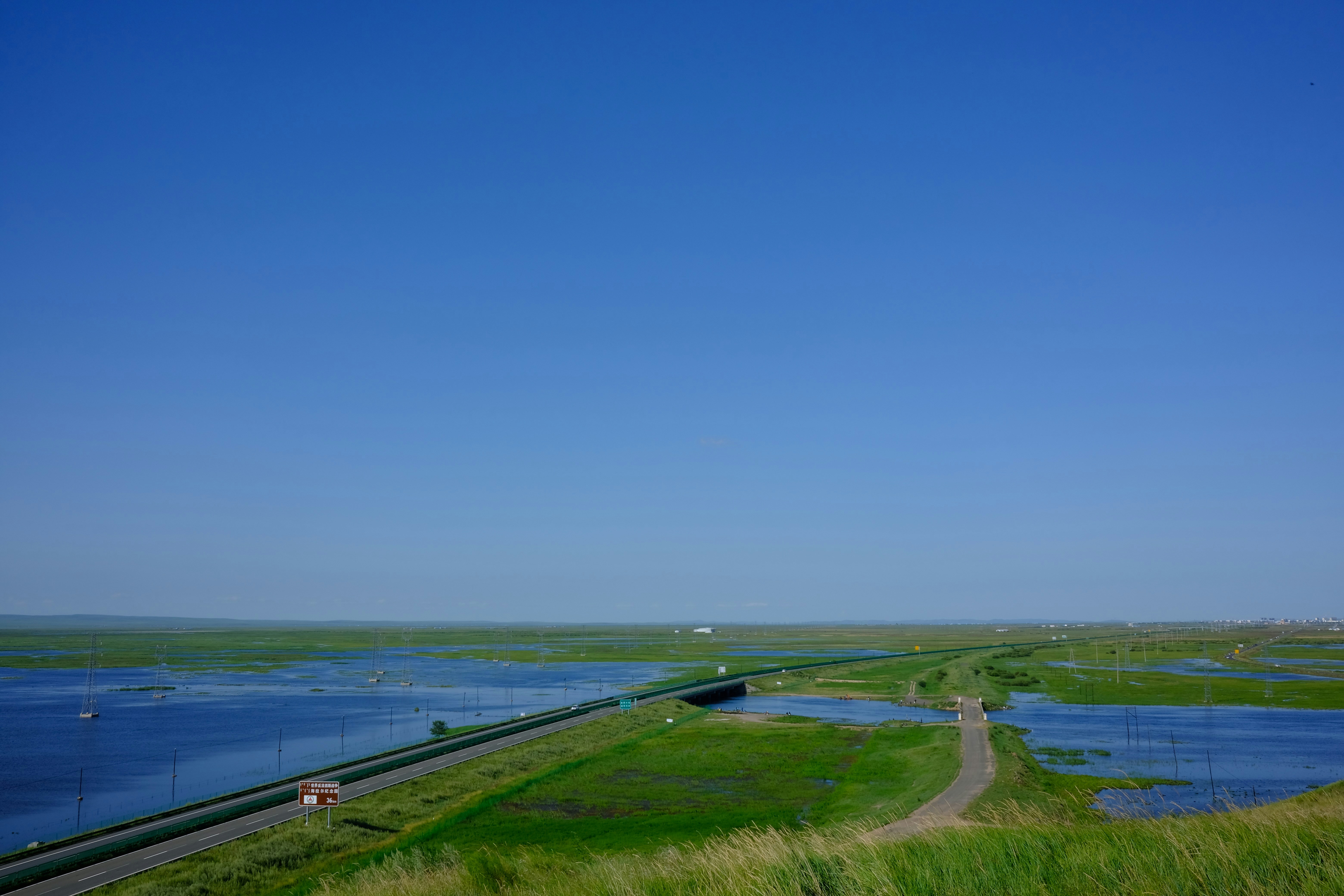 a road next to a body of water