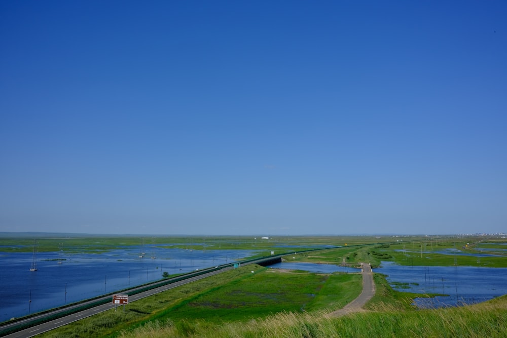 a road next to a body of water