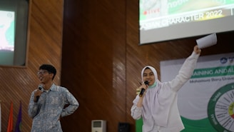 a man holding a microphone and a woman holding a microphone