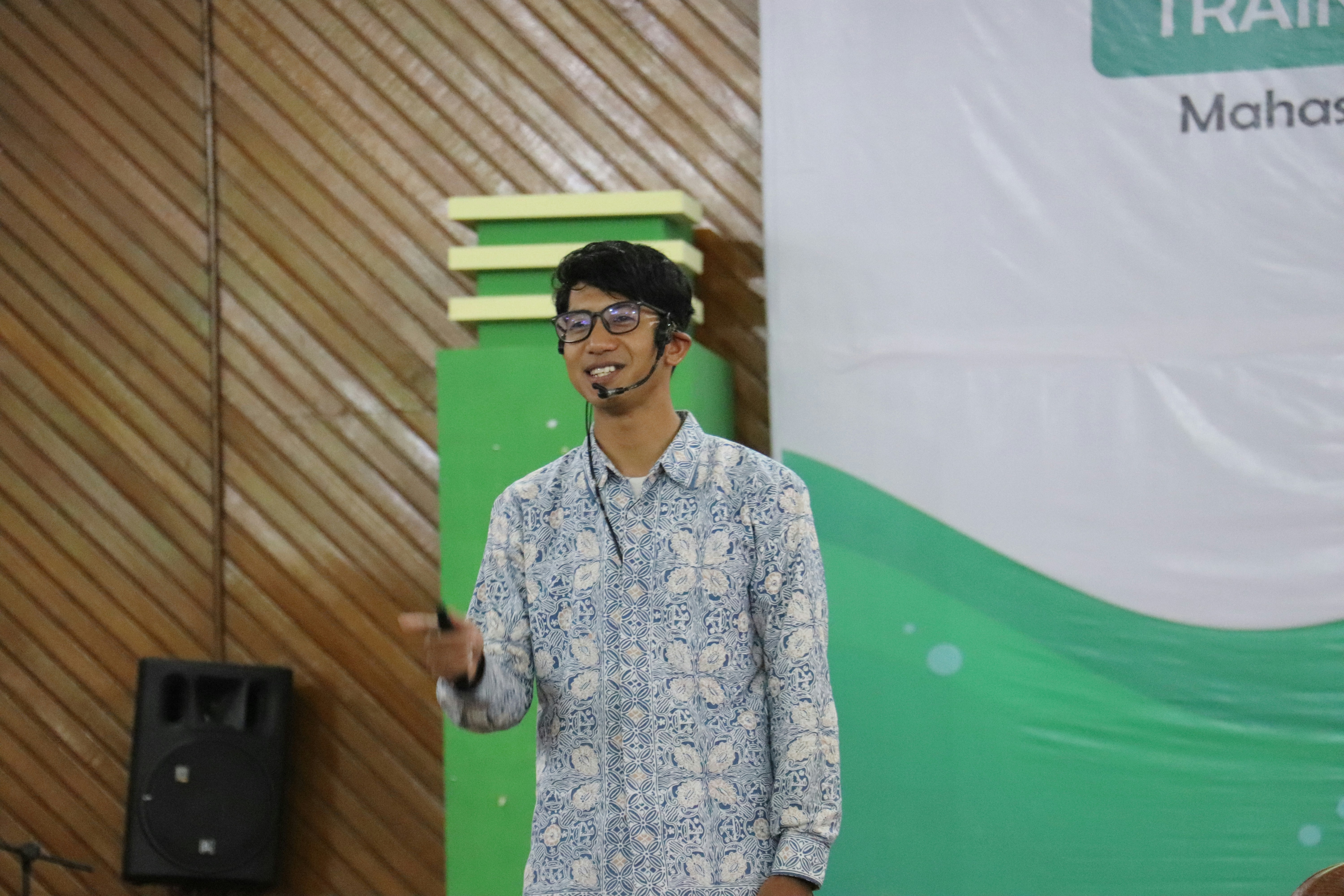 a man standing in front of a green screen